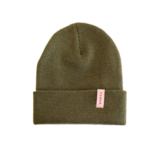 Green beanie with a red and white label on a white background